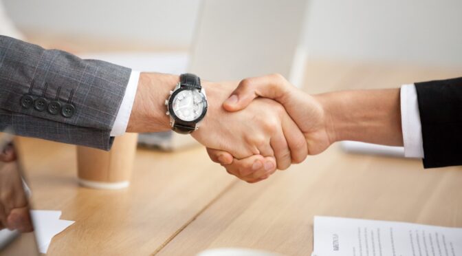 businessmen suits shaking hands