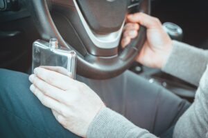 Alcohol glass and car keys on table highlighting evidence often involved in Dallas drunk driving accident injury and DWI negligence claims