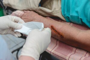 A healthcare worker treating a dog bite wound to document damages for a Dallas liability claim.