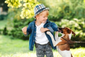 A child playing with a dog in a Dallas park, representing a dog attack claim.