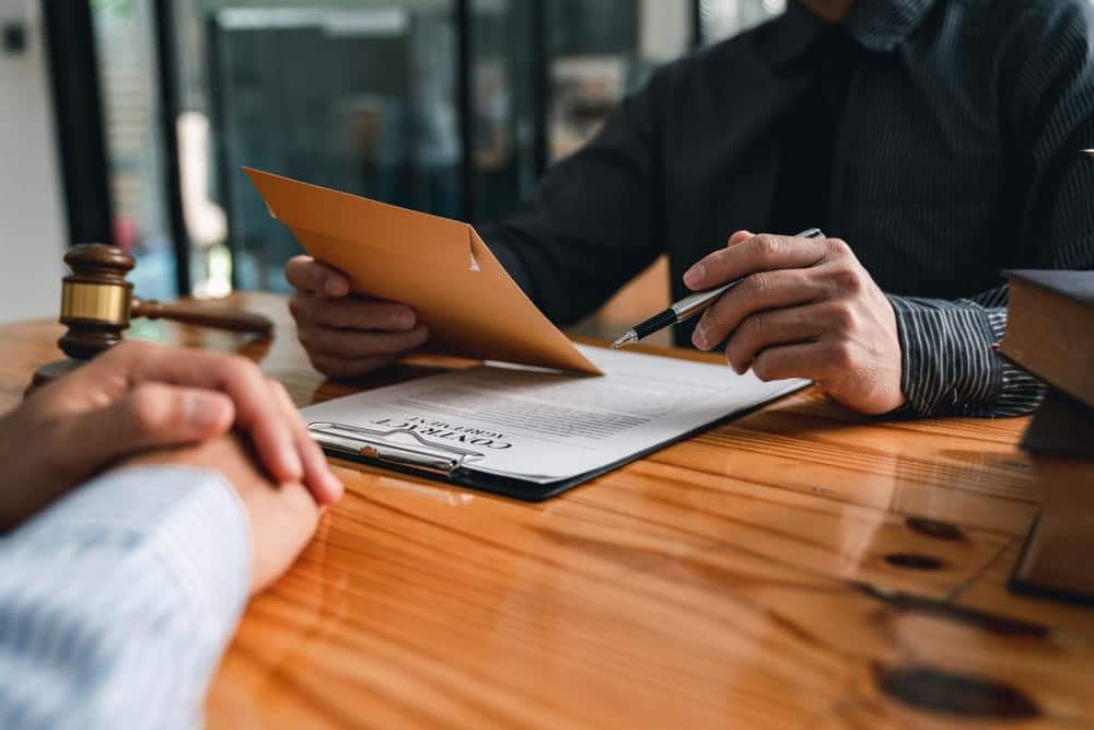 Personal injury lawyer reviewing a contingency fee agreement during a free consultation