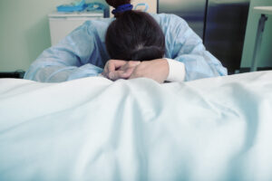 A grieving individual in a hospital setting representing a Texas wrongful death claim.
