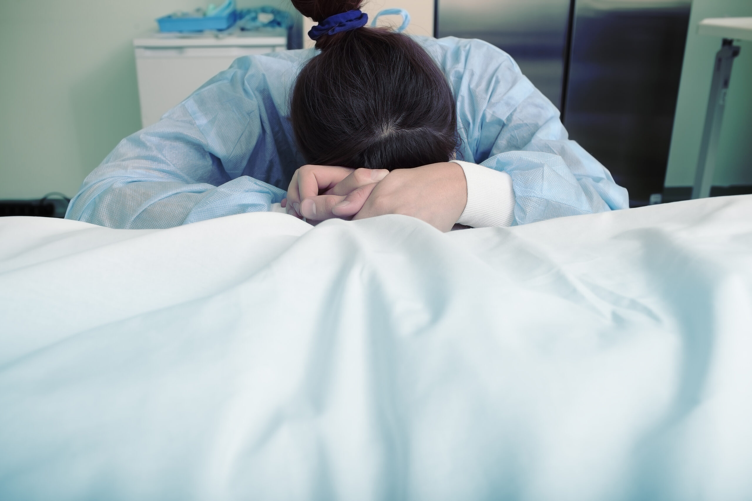 A grieving individual in a hospital setting representing a Texas wrongful death claim.