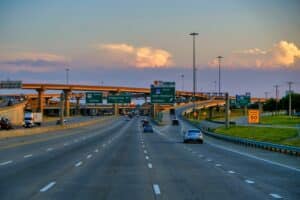 Texas highway in Dallas showing multiple lanes where the left lane is designated for passing only under state traffic laws