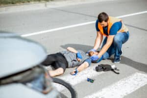 Dallas pedestrian accident lawyer scene of injured pedestrian receiving help after being struck by vehicle.