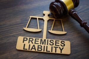 Premises liability concept with justice scales and gavel, legal issue often handled by a Dallas premises liability lawyer.