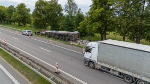 Overturned semi-truck on highway accident scene Dallas truck accident lawyer may analyze for liability