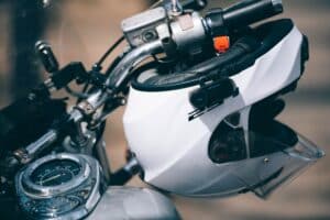 Dallas motorcycle accident lawyer explains helmet laws with close up of motorcycle helmet resting on handlebars.