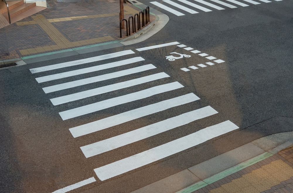 Dallas pedestrian accident lawyer view of marked crosswalk intersection with pedestrian and bike lane markings.