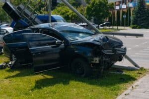 Dallas car accident lawyer image of crashed vehicle hitting pole after serious collision