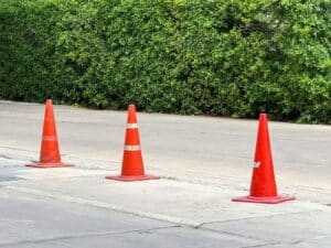 Dallas motorcycle accident lawyer highlighting road hazard with traffic cones marking dangerous pavement condition.